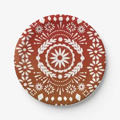 a red plate with white designs on it