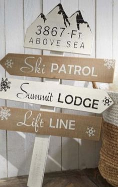 a wooden sign that says ski patrol, summit lodge and life line with snowflakes on it