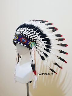 White Black & Red Feather Indian Headdress This Headdress is 100% handmade from Feathers and Leather. * Head circumference: 59 centimeters / 23 inches * Length : Short * Beads color and pattern may vary each headdress WHY US? * 100% Handmade and Eco Friendly Product * Finest Quality - Each item will go through a Quality Control process before shipping. * No Markup Price * Every purchase supports Balinese Artisans - All Artisans will keep on following their passions while providing for their Indian Hat, Eco Friendly Product, Native American Feathers, Festival Costume, Indian Headdress, Festival Costumes, Feather Hat, Red Feather, Costume Hats