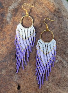 These beautiful handmade purple and white seed bead fringe earrings are sure to be the statement piece of your outfit. The perfect accent for any occasion. Made with high quality round glass seed beads, hypoallergenic earring hooks and lots of love. Earrings are 4.25 inches long from ear lobe and 1.25 inches  wide. Pair pictured is completed and will ship within 3-5 business days.  Please reach out with questions or custom earring requests.  *Purchase 3 items from Color My World Artistry and automatically receive 15% off your order.* Purple Jewelry With Beaded Fringe And Round Beads, Purple Beaded Fringe Dangle Tassel Earrings, Purple Beaded Dangle Tassel Earrings, Purple Beaded Dangle Earrings With Tiny Beads, Purple Beaded Earrings With Tassels For Gift, Purple Beaded Fringe Tassel Earrings, Purple Beaded Fringe Drop Earrings, Purple Beaded Tassel Earrings Gift, Purple Tassel Earrings With Round Beads For Gift