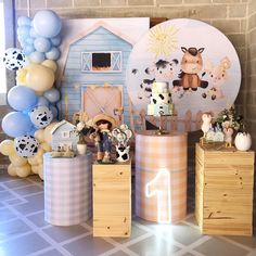 a birthday party with farm animals, balloons and decorations on the wall in front of it