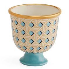 a blue and white vase with gold rim