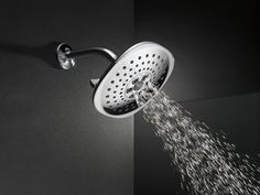 a shower head is spouting water into the air with it's spray