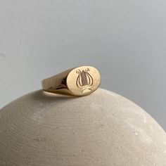 Madison designed this signet ring style specifically for the Fewer Finer collection. She deems the shape perfect for a classic signet style because it is proportionally sound and beautifully finished in a mix of smooth and matte. The signet ring is classically beautiful whether left alone or enhanced with a monogram, an engraving or stones. This style is unisex, and looks great on men and woman. For inspiration, check out some examples of how others engraved this piece here! Minimalist 14k Gold Ring With Engraving Option, Timeless Oval Engraved Ring For Formal Occasions, Refined Ring With Polished Finish As Gift, Refined Ring With Polished Finish For Gift, Minimalist Concave Dome Ring As Gift, Minimalist Open Signet Ring With Engraving Option, Refined Gift Ring With Polished Finish, Minimalist Dome Ring As Gift, Timeless Oval Engraved Ring With Polished Finish