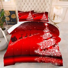 a bed with red comforter and christmas tree on it