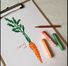 carrots and crayons are sitting on a piece of paper