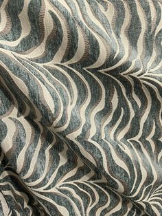 a close up view of a fabric with wavy lines on it, in grey and white