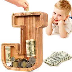 a child is playing with money in a wooden letter