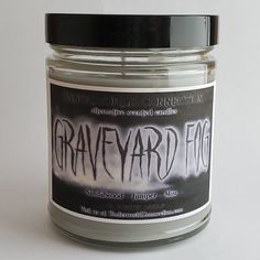 a jar that has some type of candle in it with writing on the front and bottom