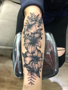 a woman's arm with flowers on it