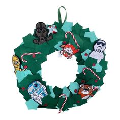 a christmas wreath made out of felt with star wars characters and candy canes on it