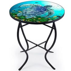 a small table with a turtle on it's side and an ocean scene painted on the top