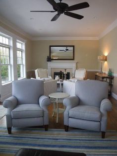 a living room with two chairs and a table