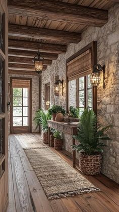 a long hallway with stone walls and wooden flooring, potted plants on the side