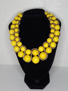 ITEM DESCRIPTION This is a vintage beaded necklace.  It features two rows of yellow round plastic beads.  There is a gold tone chain woven through the beads. See all photos please...they are part of the description. Markings/Stamps:  Unmarked MEASUREMENTS: 20 Inches Found in photos - please review all photos  **Due to age, there may be a small amount of age flaws not deemed to be worthy of noting...straw marks, bubbles, some scuffing, some particles...as typical with age/production.  I will be g Yellow Double Strand Beaded Necklace, Vintage Yellow Beaded Chain Jewelry, Vintage Yellow Jewelry With Beaded Chain, Yellow Round Necklaces For Party, Yellow Round Necklace For Party, Vintage Yellow Round Bead Necklaces, Yellow Beaded Chain Necklace For Party, Retro Beaded Chain Jewelry With Round Beads, Retro Gold Necklaces With Round Beads