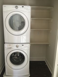 a washer and dryer are stacked next to each other in the corner of a room