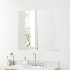 a bathroom sink with a mirror above it