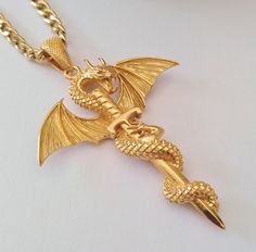 ★ Dragon Sword Pendant ★ Handcrafted Dragon Sword pendant/necklace for Men and Women. * Materials/Finishes ➤ Silver 925 (Sterling Silver) ➤ 24K Gold Plated over Silver 925 * Dimensions ➤ ~ 5.5 x 4.2 x 1.0 cm (~ 2.2 x 1.7 x 0.4 inches)/Bail: Suitable for up to ~ 4.5 mm (~ 0.18 inches) Chain * Weight: ~ 15 grams (in Silver 925) ----------------------------------------------------------------------------- IMPORTANT NOTES: ----------------------------------------------------------------------------- Rose Gold Dragon Necklace, Gold Dragon, Dragon Necklace, Precious Jewels, Dragon Pendant, Pendant Gold, Pendant Silver, Rose Gold Color, Stainless Steel Chain