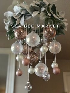 a chandelier with ornaments hanging from it's sides and the words sea be market above it