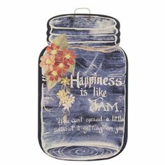 a mason jar with flowers painted on the side and words written in white writing below it