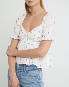 Price Comparison Few Moda $54 For Love & Lemons $138 Alice + Olivia $168 Product Details The fitted bust and relaxed body of this adorable blouse guarantees a flattering fit. Finished with embroidered floral details for an elevated touch.- Back smocking- Content: 90% Cotton, 10% Linen Style# K22WTP20156 Fit Notes - Model wearing a size XS- Shoulder seam to hem measures approx 19.5'' in length - Model measurements: 5'10.5'' Height / 32'' Bust / 25.5'' Waist / 34.5'' Hips Flirty Fitted V-neck Blouse, Flirty Cotton Tops For Day Out, Flirty Cotton Tops For A Day Out, Feminine White Puff Sleeve Tops, Flirty Cropped Top For Brunch, Flirty Fitted Short Sleeve Blouse, Spring Flirty Cotton Tops, White Puff Sleeve Top With Floral Embroidery, Flirty Cotton Tops For Spring