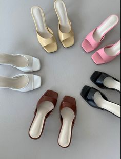 six pairs of shoes arranged in a circle on a table top, all with different colors and sizes