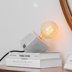 a lamp that is on top of some books