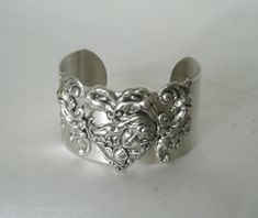 "This beautiful silver plated cuff bracelet has a silver plated art nouveau maiden and silver plated accents. 1.5\" wide." Silver Heart Bracelets For Wedding, Victorian Sterling Silver Bracelets In Antique Silver, Victorian Cuff Bracelet For Wedding, Handmade Victorian Cuff Bracelet For Wedding, Antique Heart-shaped Bracelets As Gift, Antique Heart-shaped Bracelets For Gift, Ornate Handmade Antique Silver Bracelet, Antique Heart-shaped Bracelet For Gift, Elegant Hand Cast Silver Bracelets