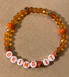 "Stretch Bracelet measures 7 3/8\" and reads BRING IT in white plastic with orange letters. You will feel empowered when you wear this bright orange stretchy bracelet! No matter the situation, you're ready, so BRING IT!  Twenty 6mm rondelle crystal beads in clear orange, five deeper orange 6mm Millefiori glass flower beads, and two 8mm opaque orange rondelle crystal glass beads make up this unique stretchy beaded EMPOWERMENT bracelet. Watch for more one of a kind ideas from my imagination, or op Feel Empowered, Orange Bracelet, Resin Bracelet, My Imagination, Flower Beads, Stretchy Bracelets, Lovely Earrings, Hamsa Hand, Bring It