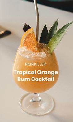 a tropical orange rum cocktail garnished with pineapple