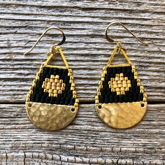 "These beaded brass teardrop shaped earrings were handwoven one bead at a time with size 11/0 Miyuki glass seed beads. A time intensive and intricate craft, each bead is carefully hand stitched in order to create an evenly woven beaded fabric. The process requires focus, patience and dedication, as even a small pair of beadwork earrings can take hours to complete. I love the contrast with the matte and shiny beads... my favorite! Handwoven Brick Stitch Beadwork Miyuki delica glass seed beads in 24k gold plated matte and shiny 14k gold filled ear wires and findings Raw brass pieces + gold plated triangle Extra durable nylon beading thread Each bead is approx. 1.6mm x 1.3mm Size: 1 1/2\" long (including ear wire) and 3/4\" wide Weight: 2g each (4g/pair)" Handmade Black Bohemian Teardrop Earrings, Bohemian Black Teardrop Beaded Earrings, Black Beaded Teardrop Earrings, Handwoven Brass Beaded Dangle Earrings, Adjustable Teardrop Beaded Earrings With Black Beads, Black Beads Teardrop Earrings, Adjustable Handwoven Teardrop Jewelry, Handmade Teardrop Earrings For Festival, Artisan Handwoven Teardrop Jewelry