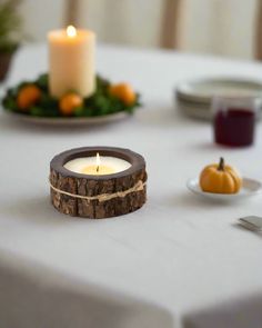 a white table topped with plates and candles