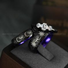 THIS LISTING IS FOR THREE (3) RINGS:  HER BAND: 6MM BLACK TUNGSTEN BAND = MOON  HER RING: 3MM .925 BLACK PLATED STERLING SILVER THREE STONE BAND PRONG SETTING (2 X WHITE DIAMOND CZ (3MM) & WHITE DIAMOND CZ (5MM)) AVERAGE WEIGHT: 4.8GMS QUALITY: AAAAA  HIS BAND: 8MM BLACK TUNGSTEN BAND = SUN  Need a custom size / design? contact us and we’ll make it for you.  Please get professionally measured for ring size and read our exchange policy carefully prior to ordering. Gothic Engraved Wedding Rings, Mystical Engraved Wedding Jewelry, Black Moon-shaped Sun And Moon Jewelry, Black Moon-shaped Jewelry With Sun And Moon Design, Black Moon Jewelry With Sun And Moon Design, Engraved Moon Shaped Jewelry For Wedding, Engraved Moon Shaped Wedding Jewelry, Mystical Crescent Jewelry For Wedding, Mystical Sun And Moon Design Jewelry For Wedding