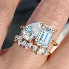 a woman's hand with an engagement ring and three stone diamond set on it