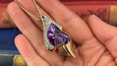 This unique freeform enhancer pendant is prong and bezel set with one (1) fantasy cut amethyst that weighs 23.23 carats. The top of the slide pendant is bead set with forty-four (44) round brilliant cut diamonds. The pendant measures 50.6mm long by 25.6mm wide and is 11.5mm deep. It hangs on a 18.5 inch long, 1.75mm fancy link chain that is finished with a lobster clasp. Pendant signed with jewelers hallmark. Luxury Amethyst Pendant Jewelry, Luxury Purple Jewelry For Collectors, Luxury Purple Teardrop Jewelry, Luxury Purple Drop Jewelry, Collectible Amethyst Pendant Jewelry, Luxury Teardrop Amethyst Jewelry, Luxury Purple Pear-shaped Jewelry, Formal Purple Necklace With Polished Finish, Elegant Heart Pendant Necklace For Collectors