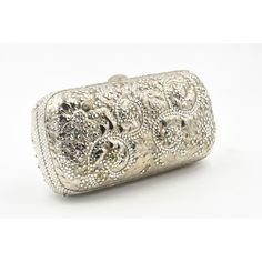 Elegant Judith Leiber silver metal and crystal oblong evening bag clutch featuring a scrolling foliage flower design on a silver - toned metal bag.  The hardware is silver.  It has a silver leather interior with a silver shoulder strap that can be folded inside when you want to wear it as a clutch.  There is a circle that folds out to hold a tassel, but it is no longer there.  Labeled ‘Judith Leiber/New York’ in the interior. 5.5” W x 3” H x 1.5” D  A similar one sold at Chrisities from Joan Riv Luxury Silver Clutch, Elegant Engraved Gold Bags, Silver Evening Bag Rectangular Case, Silver Evening Bag With Rectangular Case Shape, Luxury Metallic Silver Bag For Formal Occasions, Luxury Formal Clutch With Silver-tone Hardware, Luxury Rectangular Evening Bag For Weddings, Silver Rectangular Gala Bag, Elegant Silver Clutch For Gala