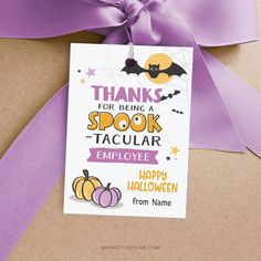 a purple ribbon tied to a brown package with a tag that says thanks for being a spook - tacular employee