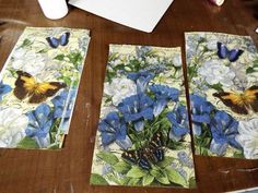 butterflies and blue flowers are on the table