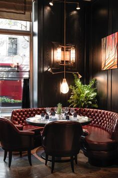 a dining room with round tables and leather chairs