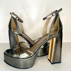 Elevate Your Style With These Stunning Sam Edelman Kamille Women's Heels. The Metallic Olive Green Color And Chunky Platform Design Make Them Perfect For Any Occasion, Whether It's A Wedding, Party, Or Formal Event. The Open Toe And Buckle Closure Add A Touch Of Elegance, While The Very High Block Heel Measuring At 4.5 Inches And Up Provides A Comfortable And Stylish Fit. These Heels Are Perfect For Any Season, Whether It's Winter, Summer, Fall, Or Spring. The Upper Material And Medium Shoe Widt Heels With Wrapped Heel, Medium Width, And Round Toe, Patent Leather Heels With 4-inch Block Heel, 4-inch Patent Leather High Heel Block Heels, 4-inch Patent Leather Block Heels, 4-inch Round Toe Patent Leather Heels, Modern Heels With 4-inch Heel And Round Toe, High Heel Patent Leather Block Heels For Party, Patent Leather High Heel Block Heels For Party, Metallic Ankle Strap Heels With 4-inch Heel