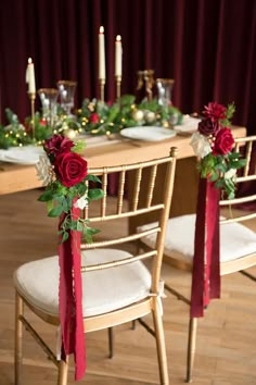 the table is decorated with red roses and greenery