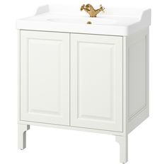 a white bathroom vanity with gold faucet and two doors on the front side