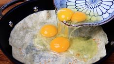 three eggs are being poured into an omelet