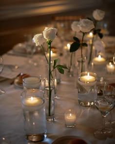 Simple single white roses and candles wedding table decor Single Stem Table Decor Wedding, Minimalist White Rose Centerpiece, Single Rose Table Centerpiece, Simple Rose Table Centerpieces, Single Rose Centerpiece Simple, Single Roses Wedding Table, Single Rose In Vase Wedding, Tea Light Candles Wedding Centerpieces, Candle Light Birthday Decoration