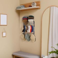 there is a shelf with hats and socks on it in the corner of this room