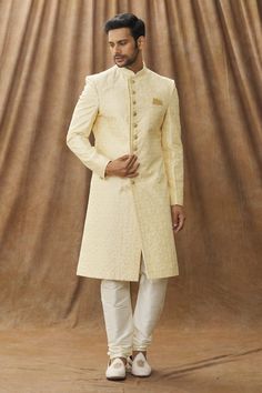 Cream sherwani with floral embroidery. Paired with cream churidar.
Component: 2
Pattern: Embroidered
Type Of Work: Floral
Neckline: Mandarin Collar
Sleeve Type: Full
Fabric: Sherwani: Art silk, Churidar: Dupion art silk, Lining: Faux satin
Color: Cream
Other Details: 
Note: The pocket square worn by the model is not for sale
Occasion: Wedding - Aza Fashions Unstitched Beige Sherwani With Naqshi Detailing, Ceremonial Bollywood Cream Churidar, Cream Traditional Wear With Dabka For Festive Occasion, Semi-stitched Cream Bandhgala With Zari Work, Cream Sherwani With Resham Embroidery For Eid, Semi-stitched Cream Bandhgala With Resham Embroidery, Cream Churidar With Naqshi On Straight Kurta, Cream Semi-stitched Bandhgala With Zari Work, Fitted Cream Kurta With Naqshi Detailing