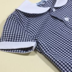 Retro styled classic gingham boys shirt. Gingham shirt with white button detail. Red, yellow, blue, black gingham. White cotton. White collar and buttons. Hand sewn finish. 6-12m Chest...29cm Nape to hem...33cm 12-18m Chest...31cm Nape to hem...35cm 18-24m Chest...32cm Nape to hem...37cm 2-3y... Chest...33cm Nape to hem...39cm 3-4y Chest...35cm Nape to hem...41cm Gift wrapped. From a smoke free and pet free home. Summer School Shirt With Buttons, Plaid Collared Shirt For School, Preppy Gingham Shirt For Summer, Preppy Gingham Collared Tops, Summer Preppy Gingham Shirt, Gingham Shirt With Buttons For Summer, Summer Gingham Shirt With Buttons, Cotton Gingham Top With Button Closure, Classic Gingham Cotton Top