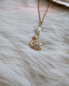 🦢  Please be aware that the pearl connector can range in sizes due to its natural nature. Some of the pearl connectors may be like the one you see in the photo and some may be a little bit bigger. This gorgeous swan necklace piece is truly one of a kind. Created with loving intentions as well. This piece makes for a wonderful gift for yourself or a loved one. 🌹 The swan charm is 18k gold stainless steel and the chain is 18k gold stainless steel.  The pearl hanging on the necklace is a real freshwater pearl 🐚 Swans symbolize so many beautiful things on its own. Swans symbolize purity, healing, elegance, soulmates, love and truth. Swans also connect to Venusian energy and the Greek goddess Aphrodite 🌹 Freshwater pearls symbolize purity, harmony, humility and femininity. Pearls connect to Swan Gifts, Aphrodite Jewelry, Aphrodite Necklace, Venus Jewelry, Swan Jewelry, Jewelry Pearl Necklace, Swan Pendant, Swan Necklace, Dainty Gold Jewelry