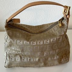 Vintage Fendi Small Handbag - Authentic. Gold / Tan Fendi Logo Fabric. Not A Shoulder Strap Bag. Handle Is Short. Pre -Owned And In Good Condition. Slight Tarnishing On The Zipper/ Hardware. Please Check Photos For Condition. Dimensions 9” X 6” X 3.5.” Fendi Dust Bag Included. All Sales Final. Fendi Bag Vintage, Authentic Gold, Fendi Handbag, Vintage Fendi, Fendi Logo, Bags Vintage, Shoulder Strap Bag, Strap Bag, Small Handbag