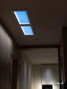 an empty room with a skylight in the ceiling